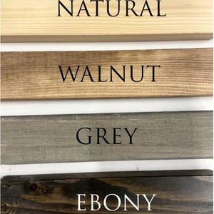 May include: Four wood samples showing different wood stains: natural, walnut, grey, and ebony.