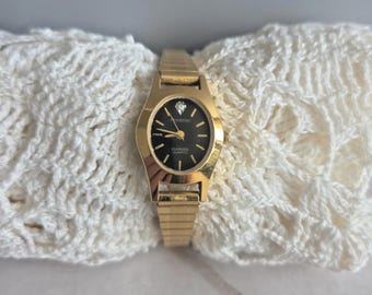 Reloj de pulsera Armitron VTG de cuarzo con diamantes en tono dorado, esfera negra, batería nueva probada