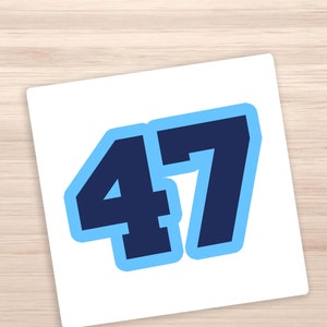 May include: A white sticker with the number 47 in bold, navy blue font with a light blue outline.