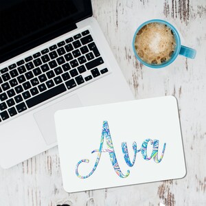 May include: White mousepad with the name "Ava" written in a colorful, swirling font.