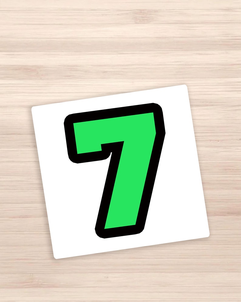 May include: A green number seven with a black outline. The number is on a white background.