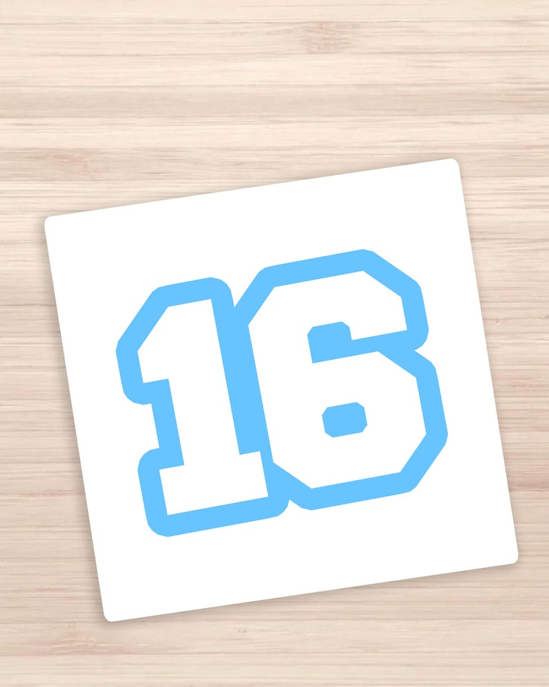 May include: A white sticker with a blue outline of the number 16. The number is in a bold, blocky font.