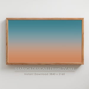 May include: A framed digital art print with a gradient of blue and orange colors. The frame is made of wood and has a light brown finish. The text "SHABACA DESIGNS | FRAME TV ART" and "Instant Download 3840 x 2160" is printed below the frame.