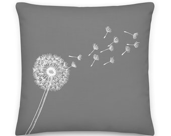 May include: A gray throw pillow with a white outline of a dandelion with seeds blowing in the wind.