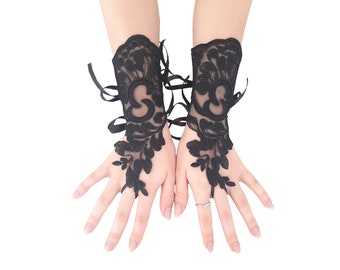 May include: A pair of black lace fingerless gloves with floral embroidery. The gloves have a ribbon tie at the wrist.