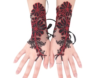 May include: A pair of black lace fingerless gloves with red floral embroidery. The gloves have a delicate, feminine design and are perfect for adding a touch of elegance to any outfit.