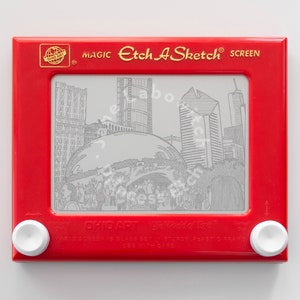 May include: A red Etch A Sketch toy with a drawing of the Chicago skyline, including the Cloud Gate sculpture, on the screen. The text "MAGIC Etch A Sketch® SCREEN" is printed on the top of the toy. The text "BIG ART" is printed on the bottom of the toy.