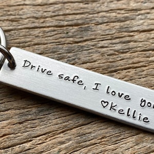 May include: Silver keychain with a rectangular tag that reads "Drive safe, I love you ♥ Kellie".
