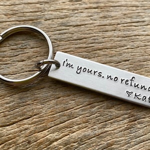 May include: Silver keychain with a rectangular tag that reads "I'm yours. No refunds. ♥ Kate".
