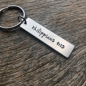 May include: Silver keychain with a rectangular tag that reads "Philippians 4:13".