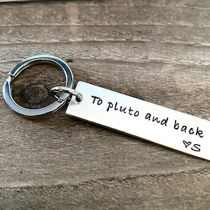May include: Silver keychain with a small tag that reads "To Pluto and back ♥ S".
