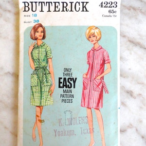 May include: Vintage Butterick sewing pattern, size 18, featuring illustrations of two dresses. The pattern includes the text "ONLY THREE EASY MAIN PATTERN PIECES" and the address "K. WOLENS Yoakum, Texas". The bust size is 38 inches.