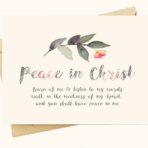 May include: A white card with a watercolor floral design and the text "Peace in Christ" in silver glitter lettering. The card also includes the text "Learn of me & listen to my words walk in the meekness of my Spirit. and you shall have peace in me."