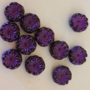 Eight Hawaii flower 8mm Czech glass beads in black with heavy purple wash
