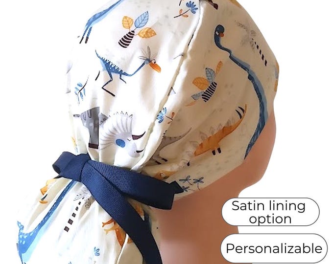 Ponytail Scrub Cap with Satin Lining and Buttons Option: Dinosaurs on White