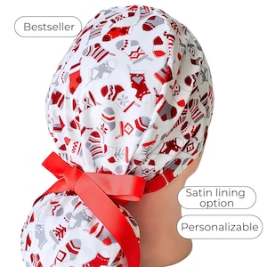 May include: A white scrub cap with a red and gray Christmas stocking pattern. The cap has a red ribbon and is labeled "Bestseller", "Satin lining option", and "Personalizable".