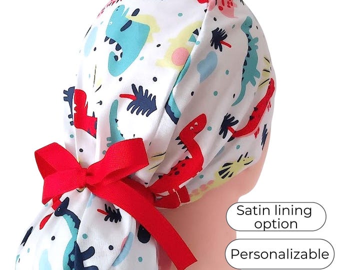 Surgical Cap Ponytail Style with Satin Lining Option: White Dinosaur Print