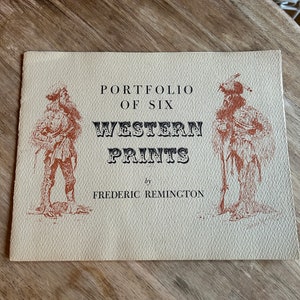 May include: A vintage book cover with a tan background and brown illustrations. The title reads "Portfolio of Six Western Prints by Frederic Remington".
