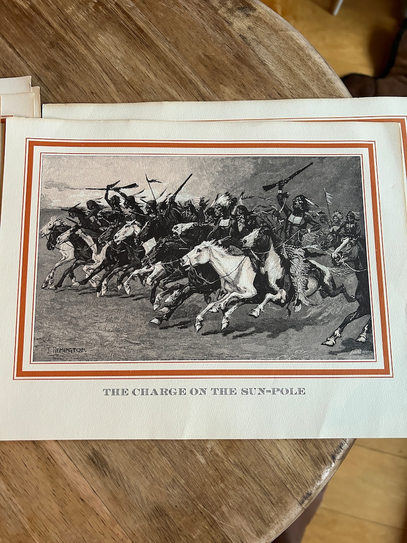 May include: A black and white illustration of a group of Native American warriors on horseback charging into battle. The image is titled "The Charge on the Sun-Pole".