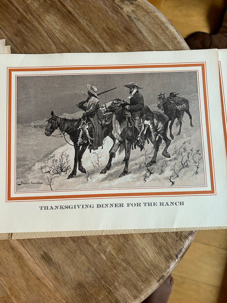 May include: A vintage Thanksgiving greeting card featuring a black and white illustration of three cowboys on horseback riding through a snowy landscape. The card has a brown border and the text "Thanksgiving Dinner for the Ranch" at the bottom.