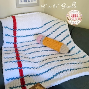 May include: A white chunky knit blanket designed to resemble a piece of notebook paper, featuring horizontal blue lines and a vertical red margin line. A matching pencil-shaped plush pillow is included in this 48 inch by 65 inch bundle.