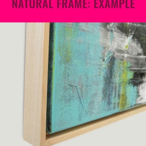 May include: A close-up of a natural wood frame with a light wood finish. The frame is surrounding a canvas painting with abstract brushstrokes in shades of blue, green, and white.