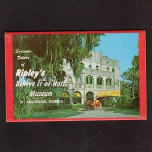 May include: A vintage postcard featuring a colorful illustration of Ripley's Believe It or Not! Museum in St. Augustine, Florida. The building is a white castle-like structure with a yellow awning and a horse-drawn carriage in front.