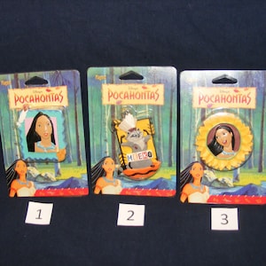 May include: Three Disney's Pocahontas character pin sets in plastic packaging. The first pin features Pocahontas in a blue frame. The second pin features Meeko the raccoon in a brown frame. The third pin features Pocahontas in a yellow sunflower frame.