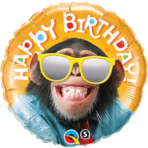 May include: A yellow round balloon with the words "Happy Birthday" printed on it. A chimpanzee wearing sunglasses and a blue shirt is in the center of the balloon.
