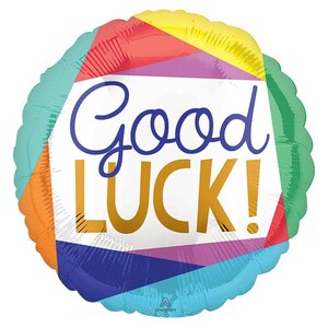 May include: A colorful balloon with a geometric pattern in shades of orange, yellow, green, blue, and purple. The balloon has the text "Good Luck!" in white and gold letters.