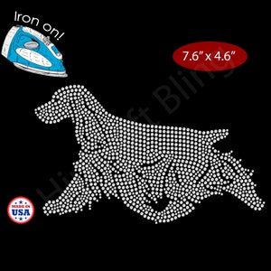 May include: Iron-on rhinestone design of a dog, approximately 7.6" x 4.6". The dog is made of white rhinestones on a black background. Includes a blue iron and a "Made in USA" sticker.