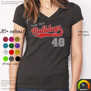 May include: Dark gray v-neck t-shirt with the word "Bulldogs" in red rhinestones and the number "48" in crystal rhinestones. The shirt has the text "YOUR TEXT" above the word "Bulldogs". The image shows a variety of color options.
