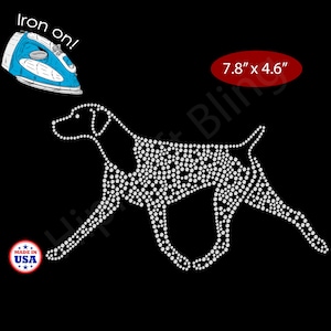 May include: Iron-on dog design made of white rhinestones on a black background. The design measures 7.8" x 4.6". Includes a blue iron graphic and a "Made in USA" sticker.