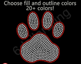 May include: A paw print design created with white and red rhinestones on a black background. The text above reads: Choose fill and outline colors 20+ colors! A small circular logo in the bottom left corner features the text: MADE IN USA.