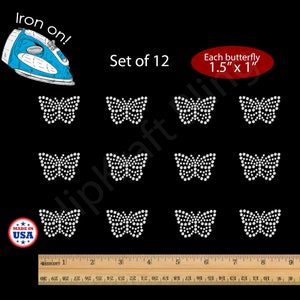 May include: A set of 12 iron-on butterfly appliques. Each butterfly measures 1.5" x 1" and is made of white rhinestones on a black background. The image includes a ruler and a "Made in USA" sticker.