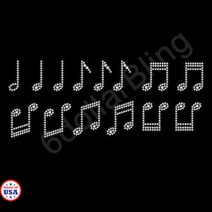 May include: A collection of musical note designs, each crafted from sparkling white rhinestones, arranged against a stark black background. The notes vary in style, including quarter notes, eighth notes, and sixteenth notes, creating a visually rhythmic pattern. A "Made in USA" emblem is in the lower left corner.