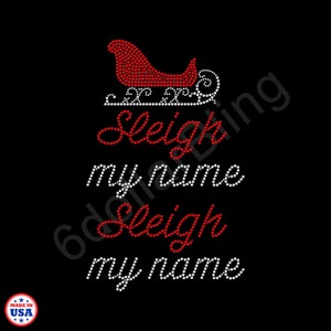 May include: Black graphic design featuring a red rhinestone sleigh and the phrase "Sleigh my name" in red and white rhinestones. The design includes a "Made in USA" logo.