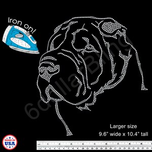 May include: Black iron-on transfer featuring a dog's head design made of white rhinestones. The image includes the text "Iron on!" and the dimensions of the design: 9.6" wide x 10.4" tall. The design is made in the USA.