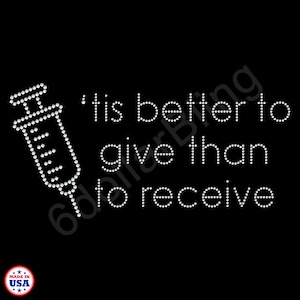 May include: Black background with a syringe illustration made of white rhinestones. The text "'tis better to give than to receive" is also made of white rhinestones. A small "Made in USA" logo is in the bottom left corner.