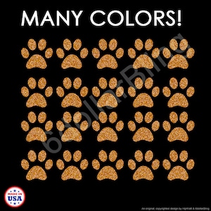May include: A black background featuring twenty orange glitter paw prints arranged in a four-by-five grid. The text "MANY COLORS!" appears in white at the top, and a circular "MADE IN USA" logo is located in the bottom left corner.