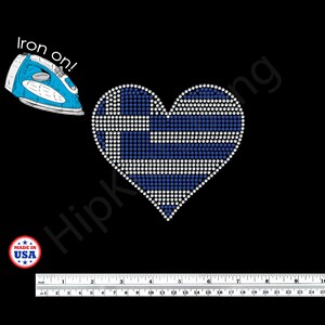 May include: A heart-shaped iron-on patch featuring the Greek flag design, made with blue and white rhinestones. The patch is on a black background, with the text "Iron on!" and "Made in USA" visible.
