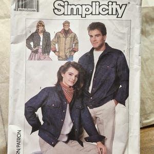May include: A Simplicity sewing pattern envelope, number 8177, size XS. The front features illustrations of individuals wearing denim-style jackets with button closures, chest pockets, and collars, paired with light-colored trousers and shirts.