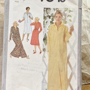 May include: A Simplicity 9048 sewing pattern envelope for a robe in size large 18-20. The cover features illustrations of four robe variations, including a long yellow zip-front robe, a short light blue robe, a red robe, and a patterned robe.