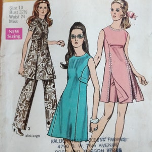 May include: A vintage sewing pattern featuring three different dress designs. The first dress is a brown and white patterned mini-dress with matching pants. The second dress is a turquoise mini-dress with a white trim. The third dress is a pink mini-dress with white lace trim. The pattern is for size 10, bust 32 1/2 inches, waist 24 inches, and is for misses.