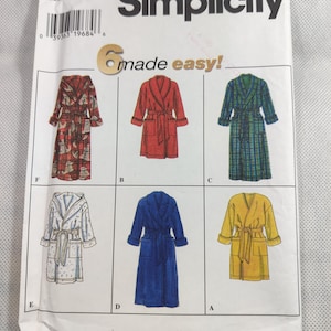 May include: Simplicity sewing pattern 7417 featuring six different robe designs. The robes are shown in various colors and patterns, including red, blue, yellow, and plaid. The text "made easy!" is also visible.