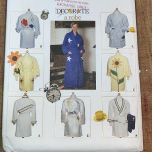 May include: A sewing pattern for a robe with six different design options. The designs include a sunflower, stars, a moon and stars, and stripes. The pattern is called "Decorate a Robe" and is for exchange only.