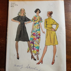 May include: Vintage Simplicity sewing pattern number 5060 for a dress. The pattern is for size 8, bust 31 1/2 inches, and is for misses. The pattern shows three different styles of dresses: a black dress with a cape-like collar, a colourful floral print dress, and a yellow dress with a high neck.