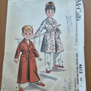 May include: Vintage McCall's printed pattern 4613 for boys' or girls' robes in two lengths. The illustration shows a child in a rust-colored robe and another in a floral robe. The pattern includes size 6 and is from Lipman Wolfe & Co.