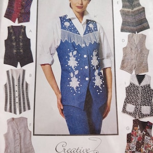 May include: A sewing pattern illustration featuring a blue denim vest with white floral embroidery, pearl accents, and fringe trim, surrounded by various other vest designs labeled A through I, including plaid, floral, and textured fabric styles.