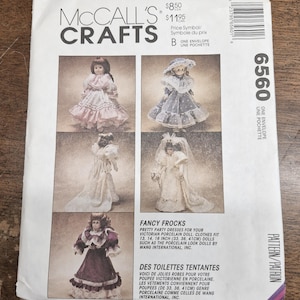 May include: McCall's Crafts pattern envelope showing fancy frocks for Victorian porcelain dolls. The envelope has text in English and French, with measurements in both inches and centimetres.